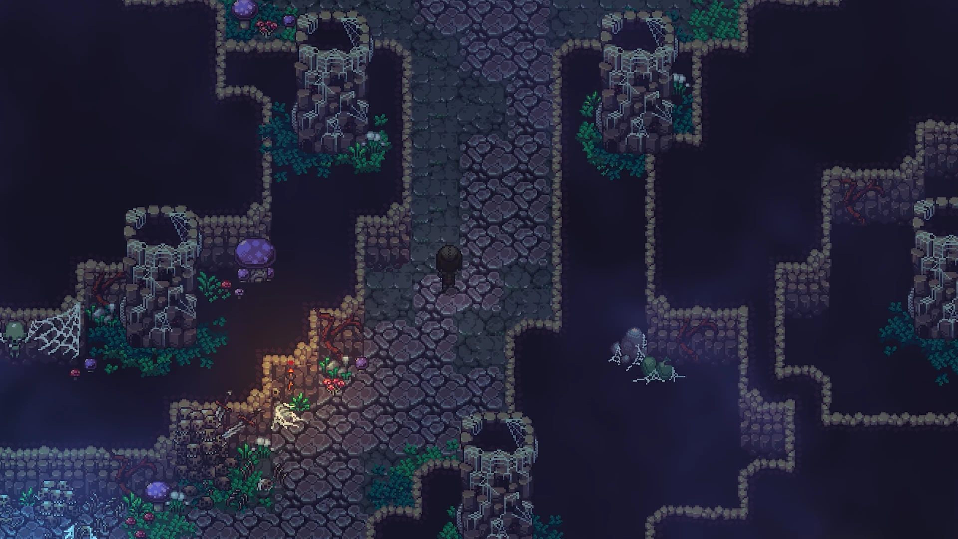 Underground cavern with a wooden plank bridge spanning dark rocky ledges