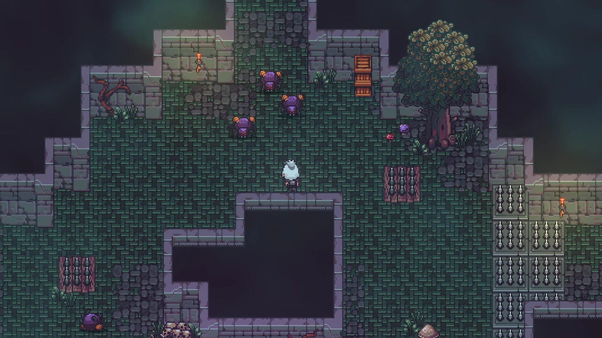 Player character in a grassy ruin with purple spider enemies