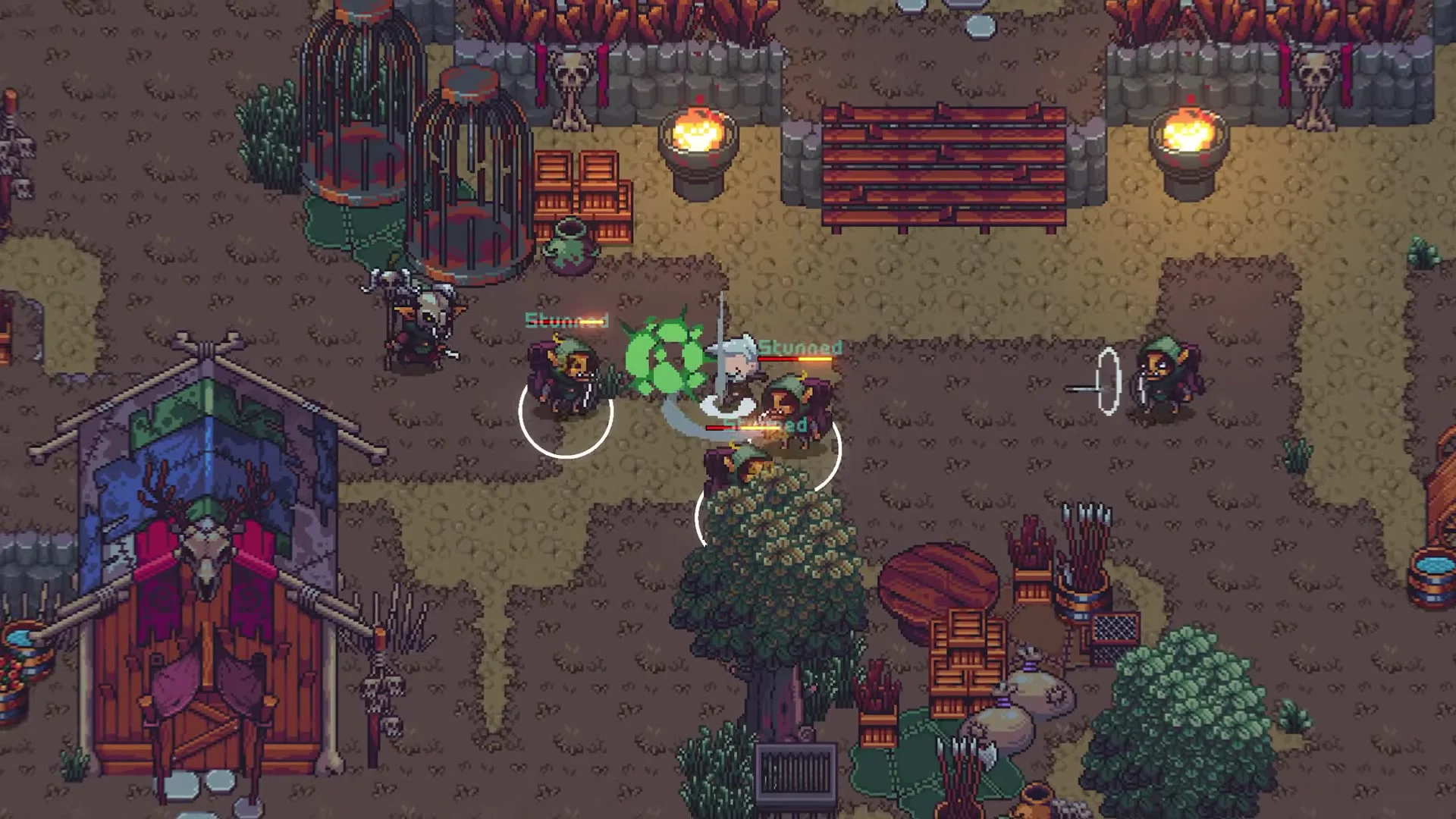 Player fighting goblin enemies with sword strikes near cages and torches